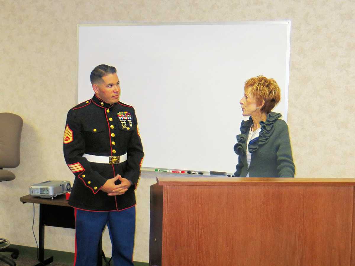 Marine Corp waiting for a check for Toys for Tots