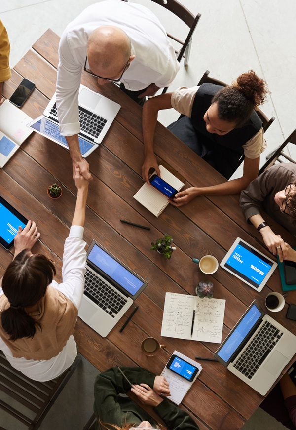 group of business professionals working together at a large table